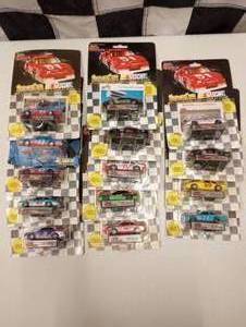 lot 75 image: Racing Champions 164 Scale Die Cast Cars With Collectors Card and Display Stand