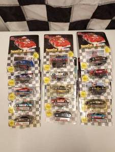 lot 77 image: Racing Champions 164 Scale Die Cast Cars With Collectors Card and Display Stand