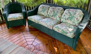 lot 49 image: Lloyd and Flanders Forest Green Wicker Sofa and Chair with Fun Floral Cushions