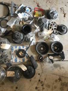 lot 76 image: Huge Parts Lot - Includes the following  Much More - Misc. Chevy Restored Pulleys, Big Block and Small Block, Disc Brakes Dust Shields New, Alternator Pulleys, Sifters Etc.