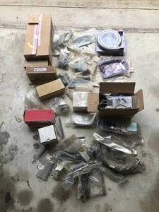 lot 85 image: Huge lot of Parts - Includes  More - Chevelle Door latches, Camaro exhaust hangers, braded hose, brake hoses, suspension parts, bumper brackets
