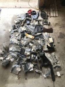 lot 86 image: Huge lot of Parts - Includes  More - 1967-69 Camaro leaf spring brackets, steering column mounts, horns, water necks, powering steering bracket, Camaro and Chevelle