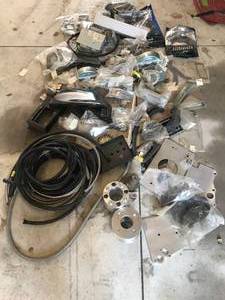 lot 89 image: Huge lot of Parts - Includes  More - Braded Hose Aeroquip wheel spacers, 1967 Camaro Fender Extension, motor adapter plates, body seals, weather stripping, Ken Harrison Stereo, MORE