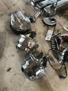 lot 90 image: Huge lot of Parts - Includes  More - Harley Air Cleaner, chrome brake booster, velocity stack, Blueprint covers, Misc. Harley Parts