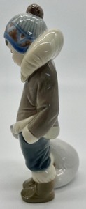 lot 352 image: Lladro Eskimo Boy with Pet Porcelain Figurine