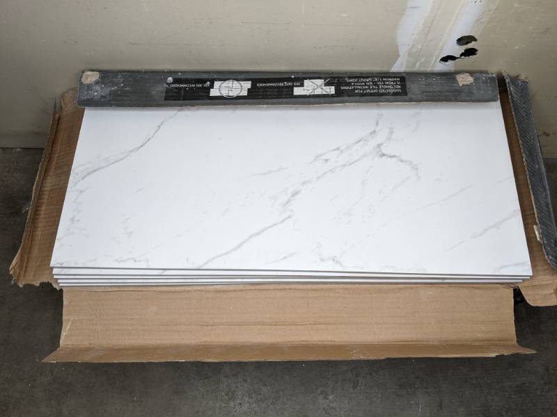 lot 23 image: 25 Premium Porcelain Carrara & 5 Pietra Carrara White Porcelain Stone Look Floor and Wall Tiles 12 in. x 24 in. O