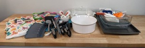 lot 144 image: Large Assortment of Kitchen Items - Vintage Sears Corningware, Kitchen Utensils, New Towels, Trivets, and more K