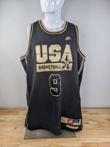lot 53 image: Nike Michael Jordan USA Black & Gold Jersey Size 2XL K