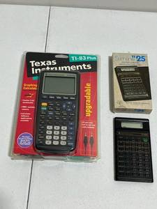 lot 27 image: New Texas Instruments TI-83 Plus Graphing Calculator and Vintage TI-25 Slimline Pocket Calculator