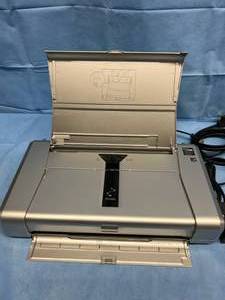 lot 27 image: MSRP $400 Canon PIXMA iP iP100 Portable Inkjet Printer, Color - Rugged, Lightweight, High Performance & Mobile Works Great - Surface Scuffs Present