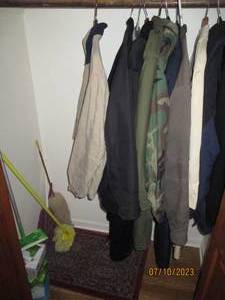 lot 72 image: floor cleaning supplies, rug and assortment of mens size XL outerwear jackets