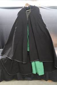 lot 126 image: RENISSANCE ATTIRE. HUGE BLACK HOODED CLOAK WITH GREEN UNDER DRESS AND BELT
