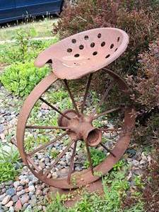 lot 14 image: 35 Metal Tractor Saddle on Metal Tractor Wheel theme Yard Art