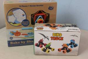 lot 93 image: Bake by Shape 12pc Baking Set  Dino Truck Toy