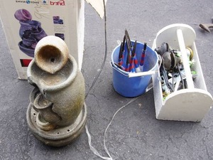 lot 32 image: Lawn & Garden...Water Fountain, Pail of Stake Solar Lights, Wood Tote of Sprinkler Faucet Hose Attachments Etc.
