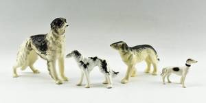 lot 148 image: Group of Four Ceramic Dog Statuettes