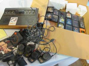 lot 44 image: Atari Game System with assorted games and a vintage baseball card.