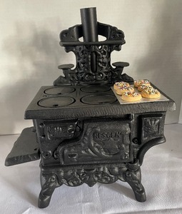 lot 86 image: Rescen Cast Iron Stove and Byers Choice Figurine