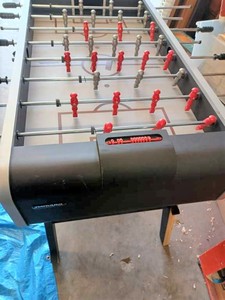 lot 40 image: Varsity Foos Ball Table with Two Black & White Soccer Balls, Some of the Melamine is Peeling from the legs of the table