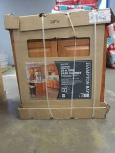 lot 206 image: Hampton Bay Hampton 30 in. W x 24 in. D x 34.5 in. H Assembled Sink Base Kitchen Cabinet in Medium Oak (CHIPS IN SIDEWALL & BACK PANEL, SEE PHOTOS)