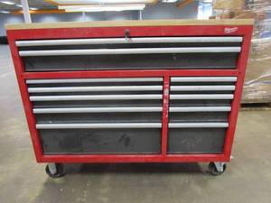 lot 214 image: Milwaukee 52 in. W x 22 in. D 12 Drawer Heavy Duty Mobile Workbench Cabinet in Red (DOORS ON LEFT SIDE DO NOT OPEN, HAS KEYS, LOCK DOES NOT TURN, TOP DRAWERS STICK, SCRATCH & DENT)
