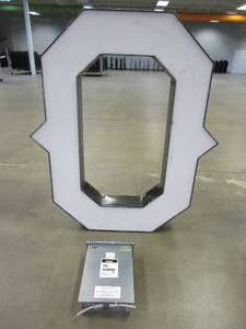 lot 106 image: Lighted Letter O Outdoor Signage With Transformer. Approximate Dimensions 35 x 5.25 x 42.5 Tall - USED FOR RETAIL BRAND MN HOME OUTLET.