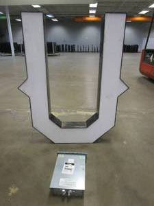 lot 107 image: Lighted Letter U Outdoor Signage With Transformer. Approximate Dimensions 35 x 5.25 x 42.5 Tall - USED FOR RETAIL BRAND MN HOME OUTLET.
