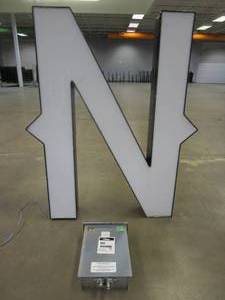 lot 114 image: Lighted Letter N Outdoor Signage With Transformer. Approximate Dimensions 35 x 5.25 x 42.5 Tall - USED FOR RETAIL BRAND MN HOME OUTLET.