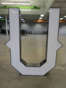 lot 118 image: Lighted Letter U Outdoor Signage, Transformer Not Included. Approximate Dimensions 35 x 5.25 x 42.5 Tall - USED FOR RETAIL BRAND MN HOME OUTLET.
