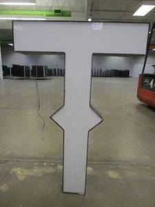 lot 119 image: Lighted Letter T Outdoor Signage, Transformer Not Included. Approximate Dimensions 29 x 5.25 x 42.5 Tall - USED FOR RETAIL BRAND MN HOME OUTLET.