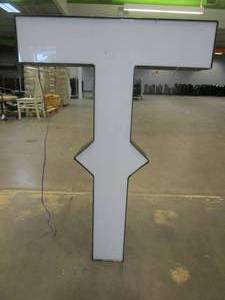 lot 120 image: Lighted Letter T Outdoor Signage, Transformer Not Included. Approximate Dimensions 29 x 5.25 x 42.5 Tall - USED FOR RETAIL BRAND MN HOME OUTLET.