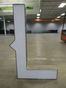 lot 123 image: Lighted Letter L Outdoor Signage, Transformer Not Included. Approximate Dimensions 29 x 5.25 x 42.5 Tall - USED FOR RETAIL BRAND MN HOME OUTLET.