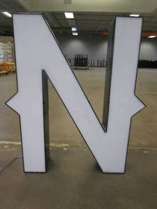 lot 125 image: Lighted Letter N Outdoor Signage, Transformer Not Included. Approximate Dimensions 24 x 5.25 x 28 Tall - USED FOR RETAIL BRAND MN HOME OUTLET.