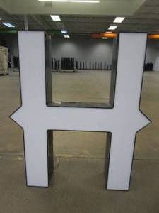 lot 126 image: Lighted Letter H Outdoor Signage, Transformer Not Included. Approximate Dimensions 24 x 5.25 x 28 Tall - USED FOR RETAIL BRAND MN HOME OUTLET.