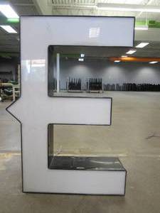 lot 129 image: Lighted Letter E Outdoor Signage, Transformer Not Included. Approximate Dimensions 19 x 5.25 x 28 Tall - USED FOR RETAIL BRAND MN HOME OUTLET.