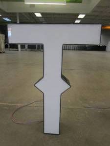 lot 132 image: Lighted Letter T Outdoor Signage, Transformer Not Included. Approximate Dimensions 20 x 5.25 x 28 Tall - USED FOR RETAIL BRAND MN HOME OUTLET.