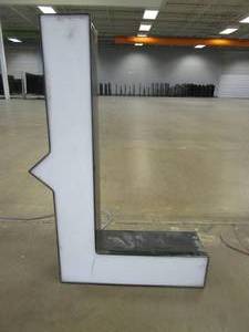 lot 133 image: Lighted Letter L (Slight Crack in Front) Outdoor Signage, Transformer Not Included. Approximate Dimensions 19 x 5.25 x 28 Tall - USED FOR RETAIL BRAND MN HOME OUTLET.