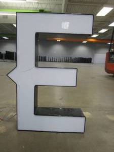 lot 134 image: Lighted Letter E (Crack in Front) Outdoor Signage, Transformer Not Included. Approximate Dimensions 19 x 5.25 x 28 Tall - USED FOR RETAIL BRAND MN HOME OUTLET.