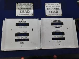 Four antique gas pump signs