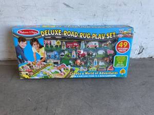 lot 17 image: Melissa & Doug Deluxe Activity Road Rug Play Set with 49pc Wooden Vehicles and Accessories