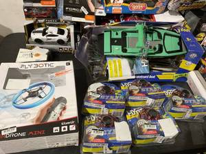 lot 114 image: Large Lot of Toys Including Hotwheels, SkyViper Drones, Cyber Spin Motorized Flying Discs, Sharper Image Gravity Rover, and More