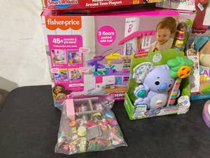 lot 116 image: Lot of Assorted Toys by Fisherprice, Barbie, Vtech, Disney, Sesame Street and More
