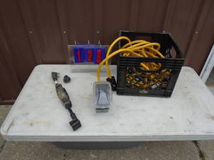 RV cord with outlet box adapter plug in milk crate. As shown.