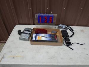 Flat of digital camera, led flasher & battery charger. As shown.