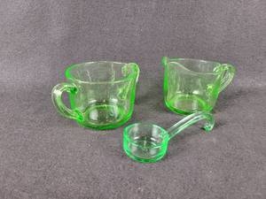 lot 1076 image: Set of Green Glass Sugar and Creamer with Scoop - Scoop is Heisey Glass Co.