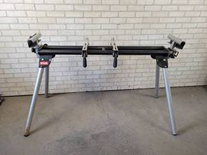 lot 548 image: RYOBI Folding Miter Saw Stand with Brackets Model No. A18MS01 - NO SHIPPING