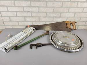 lot 678 image: Warranted Superior Hand Saw, Light, Wrenches and Hubcap - NO SHIPPING