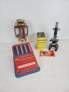 lot 179 image: Lot of Vintage Items - Tin Litho Adding Machine, Small Oil Lantern, and Microscope with (5) Sets of Prepared Slides