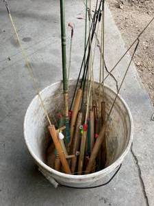 lot 58 image: Bucket of Vintage Wooden Ice Fishing Rods