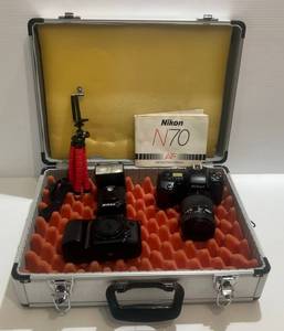 lot 6 image: Two Nikon Cameras In Hard Case 1 Nikon N6006 1 N70 (Has Sticky Rubber On Back)